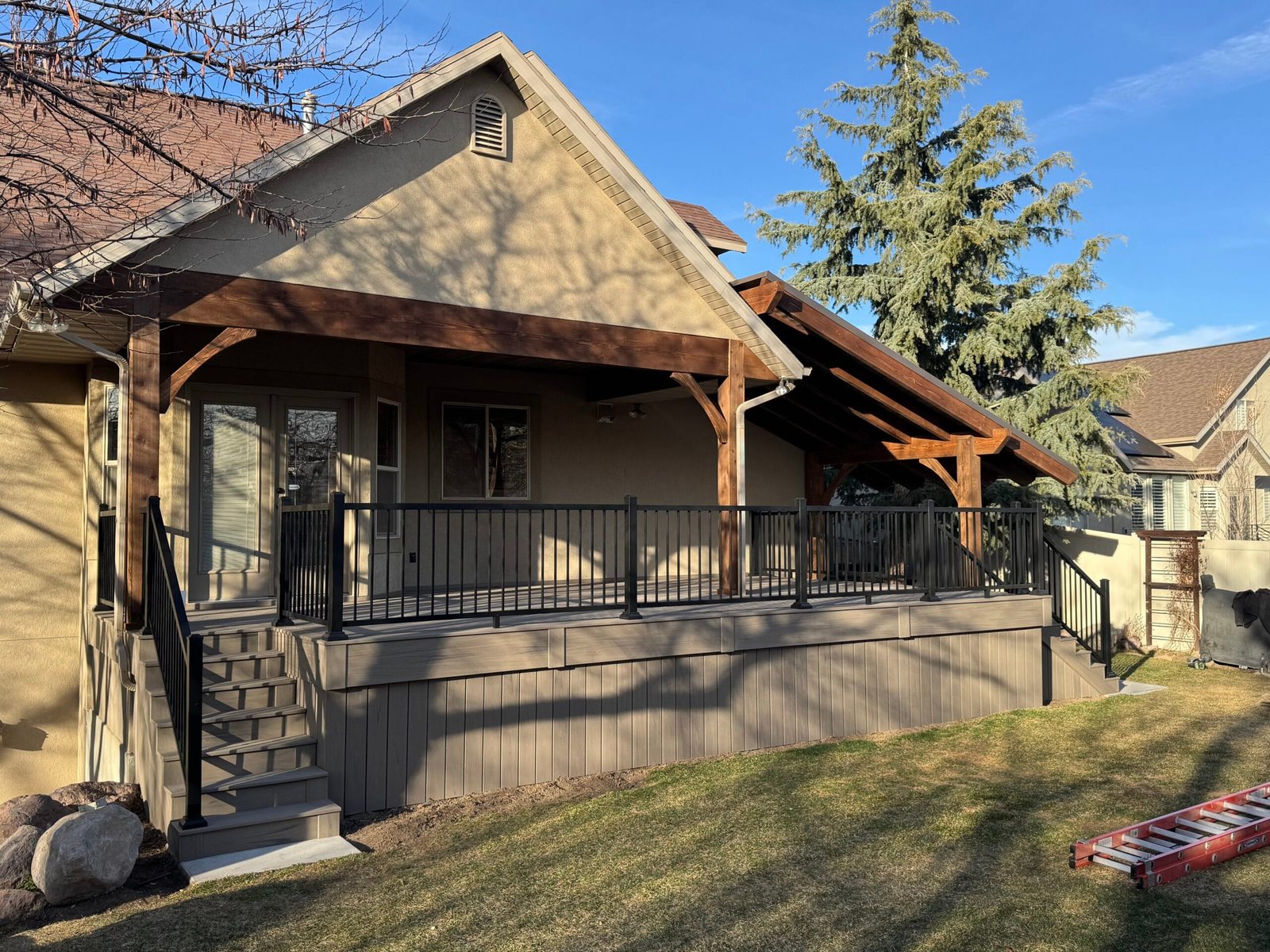 Composite deck with covered structure and railing